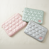 Three quilted mats in pink, green, and white on a white background