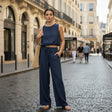 Woman in navy blue outfit standing on a city street