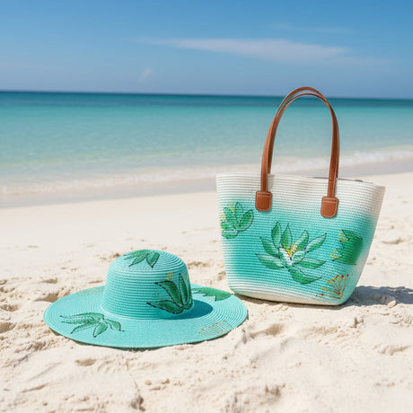 Turquoise sun hat and bag with floral design on a sandy beach