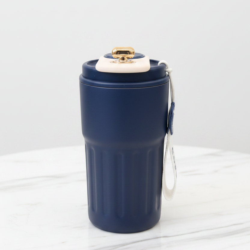 Navy blue tumbler with a gold lid on a white background