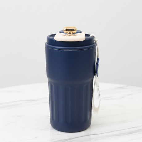 Navy blue tumbler with a gold lid on a white background