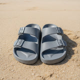 Pair of gray sandals on a tiled floor