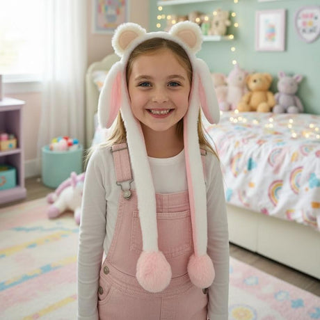 White plush animal ear headband with pale pink inner ears worn by a smiling young girl