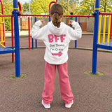 Back of the white BFF hoodie showing the pink lettering and smiley faces
