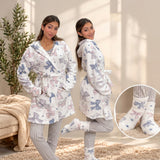Two women in white hooded fleece robes with bow print, with a close up of the matching bow socks