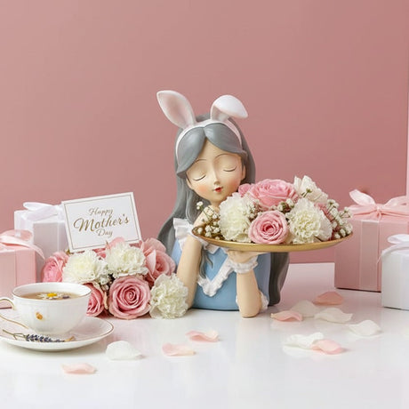 Grey haired bunny figure whose gold tray brims with roses, a gold rimmed teacup beside