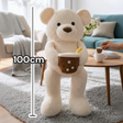 Cream boucle teddy bear standing upright with a brown boba cup plush tucked against its chest, shown at 100cm