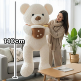 Woman standing beside the white curly teddy bear with a 140cm measuring line