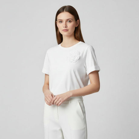 Woman wearing a white tshirt with a floral design on a light gray background