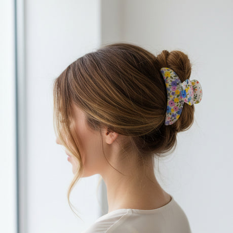 Cream floral claw clip in loose waves, close side view of the print