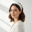 White matte headband worn with short waves in soft daylight