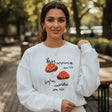 White mushroom sweatshirt shown with the relaxed drop shoulder sleeve raised