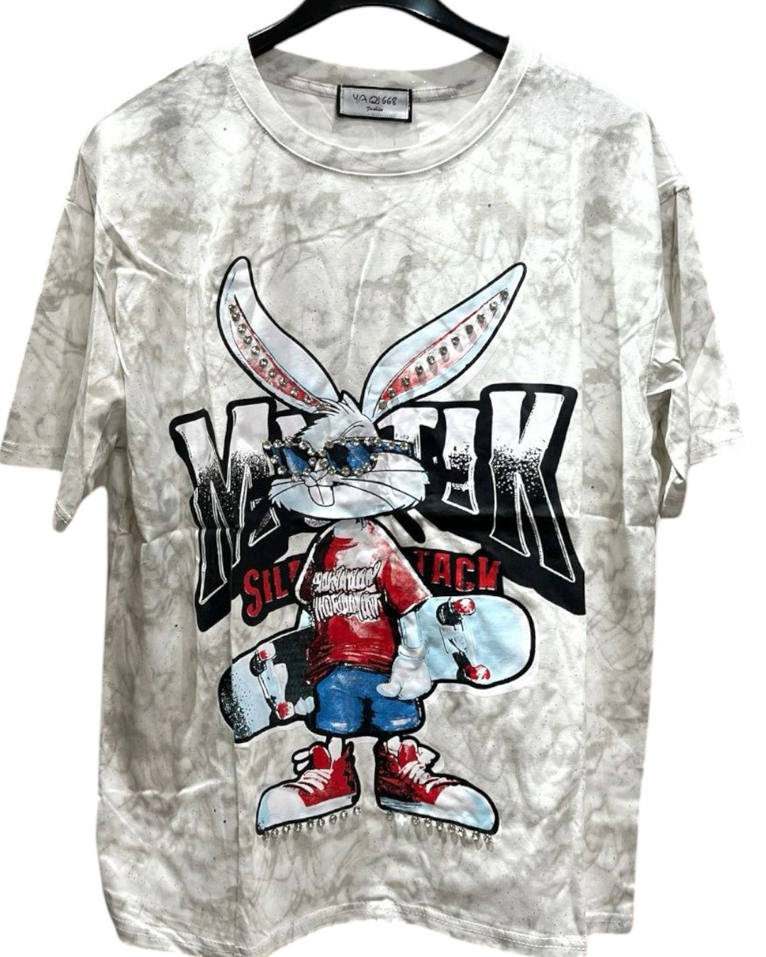 White oversized tshirt with a graphic print of a stylized rabbit wearing a red shirt and holding a skateboard