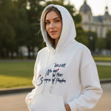 Woman wearing a white hoodie with a navy script slogan and red dot accents