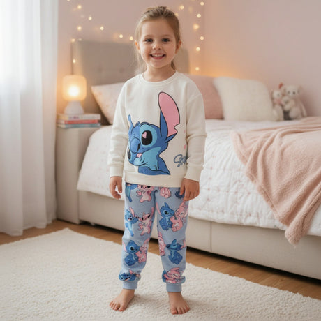 Full length cream long sleeve top and light blue all over Stitch print joggers on a young girl