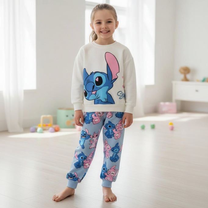 Girl wearing a cream sweatshirt with a large blue Stitch print and pale blue printed joggers