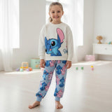Girl wearing a cream sweatshirt with a large blue Stitch print and pale blue printed joggers