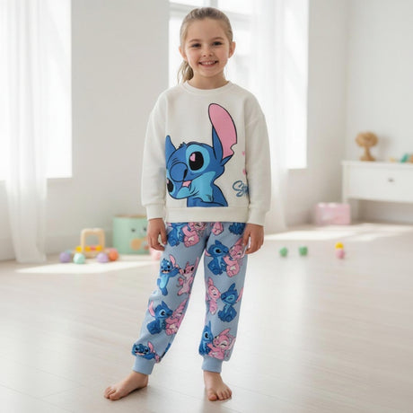Girl wearing a cream sweatshirt with a large blue Stitch print and pale blue printed joggers
