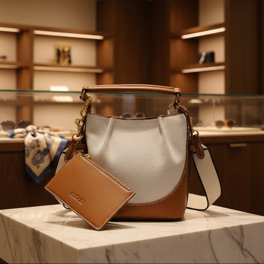 Designer handbag with matching wallet on a marble surface in a store setting