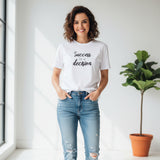 White tshirt with 'Success is a decision' text on a white surface