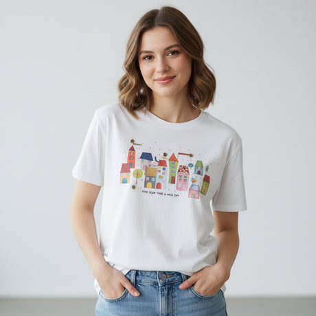 White tshirt with colorful village design on a white background