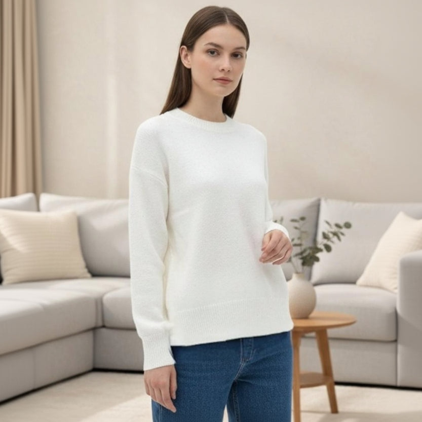 Plain white long sleeve wool top in fine knit, worn in a living room setting