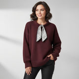 Burgundy wool top styled with black trousers, black and silver scarf bow at the neck