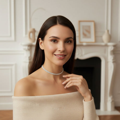 Woman wearing a double necklace in a room with a fireplace