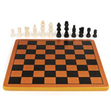 Empty wooden chess board with one of each cream and black piece lined up behind it