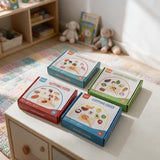 Four wooden cutting play sets in food, ice cream, vegetable and fruit boxes on a kids dresser