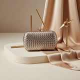 Rose gold woven metallic evening clutch with knot clasp