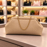 Beige woven pouch clutch with a gold curb chain strap and a soft rounded top