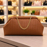 Camel brown woven clutch bag with a pleated top edge and a gold chain strap