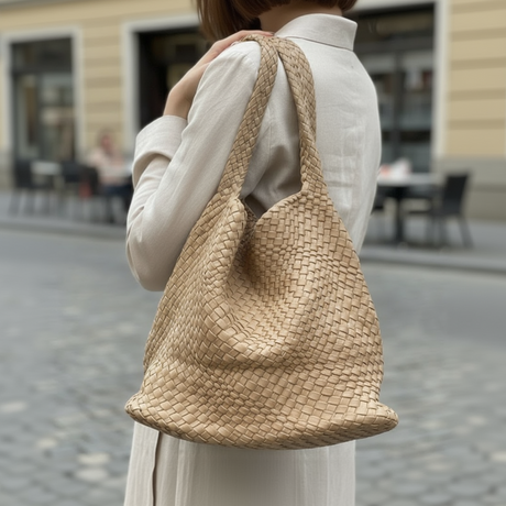 Back view of beige woven shoulder bag with strap detail