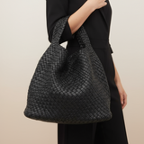 Black woven shoulder bag with braided pattern