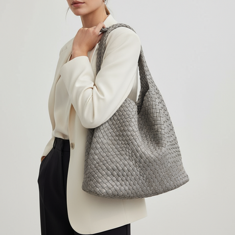 Woman carrying a grey woven shoulder bag, casual daily look