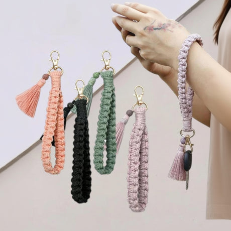 Woman wearing a purple macrame wristlet keychain on her wrist with keys attached