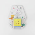 Yellow 3x3 magic cube in a white dinosaur print blister pack