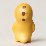 Back of a yellow dinosaur squishy showing three brown spots and a short tail