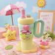 Colorful children's cup with handle and umbrella design on a pastel background