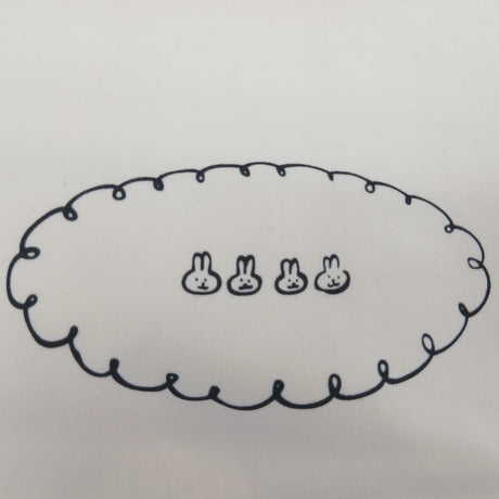 Embroidered scalloped chest motif on a cream pyjama top