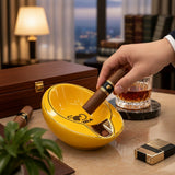 Man settling his cigar into the deep yellow bowl on a marble desk at dusk