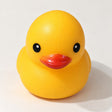 Yellow rubber duck squishy with a red beak and black eyes, front view