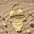 Yellow shell trim bikini flat lay on sand, Jack Gifts Online Lebanon