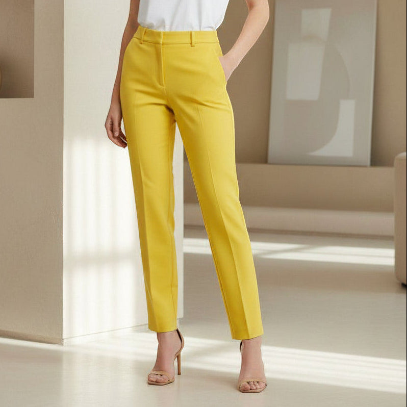 Person wearing bright yellow pants in a minimal indoor setting