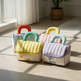 Colorful children's bags with handles on a wooden floor.