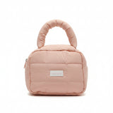 Pink quilted handbag with a visible brand label on a white surface.