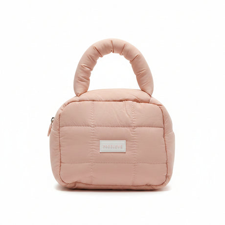 Pink quilted handbag with a visible brand label on a white surface.