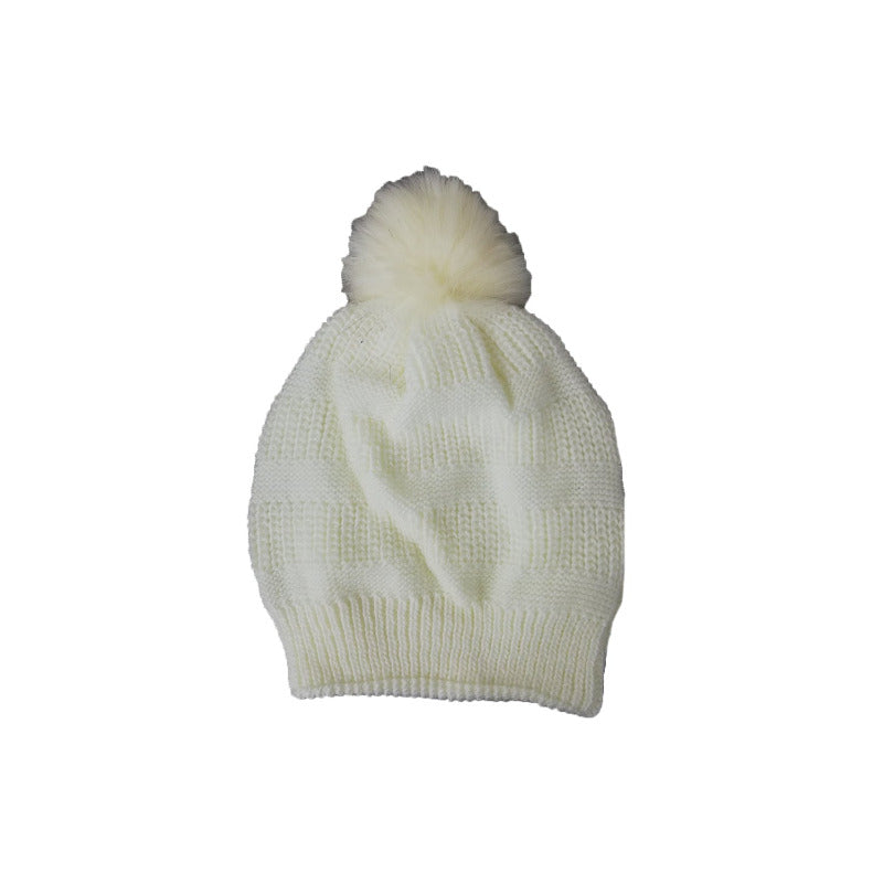 Cream white beanie on a plain background with a fluffy pom